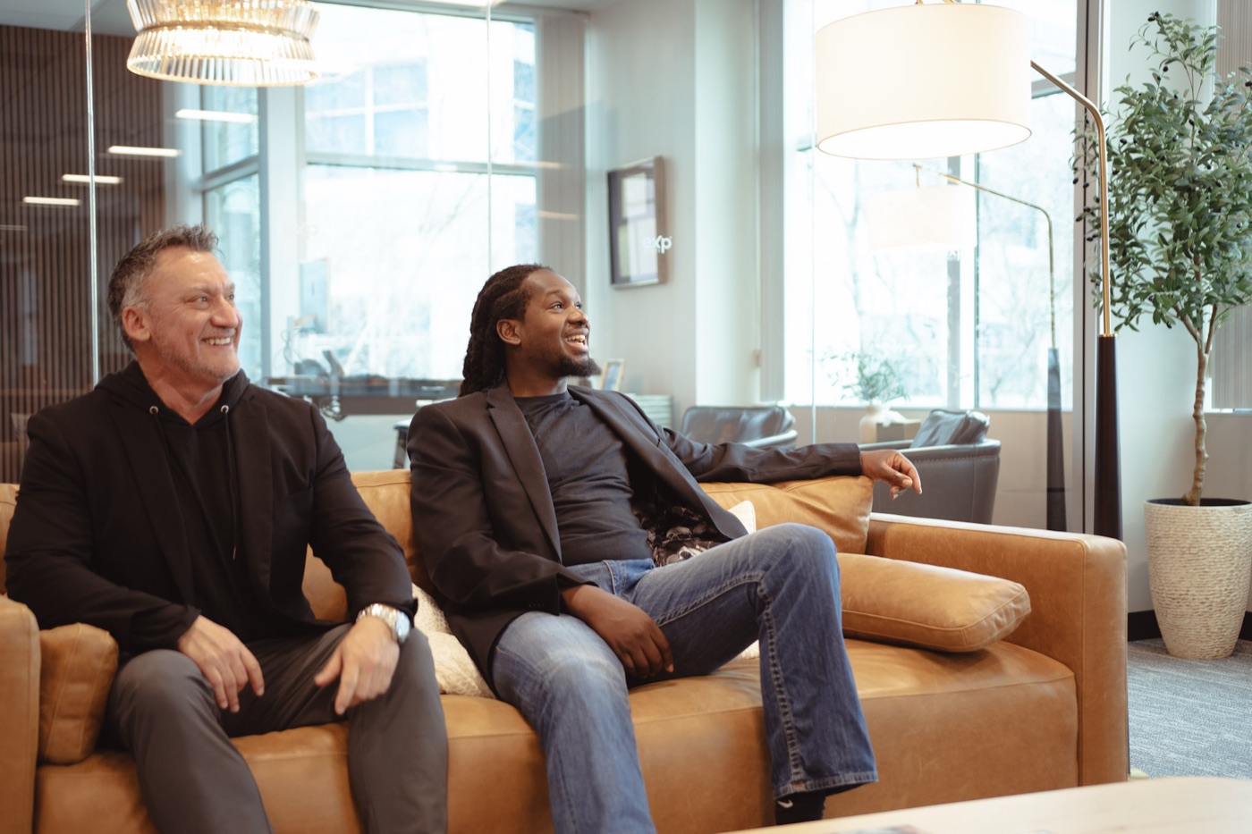 Jeff Morazzini sitting with Ike in a bright office lounge